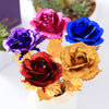 red purple rose red blue and golden rose placed on table top view